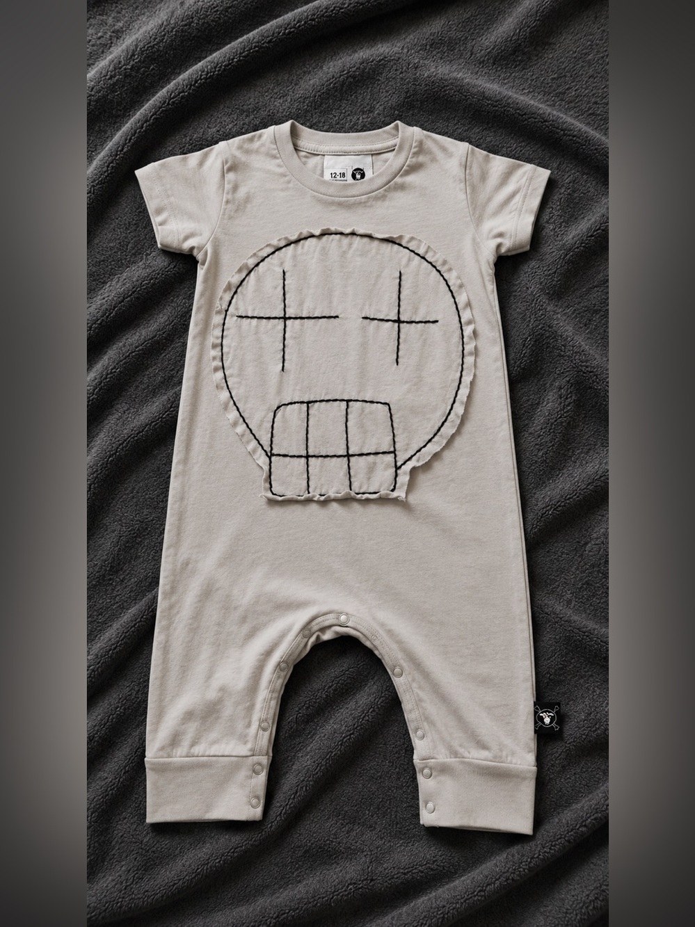 Nununu Beige Baby One-Piece with Skull Patch